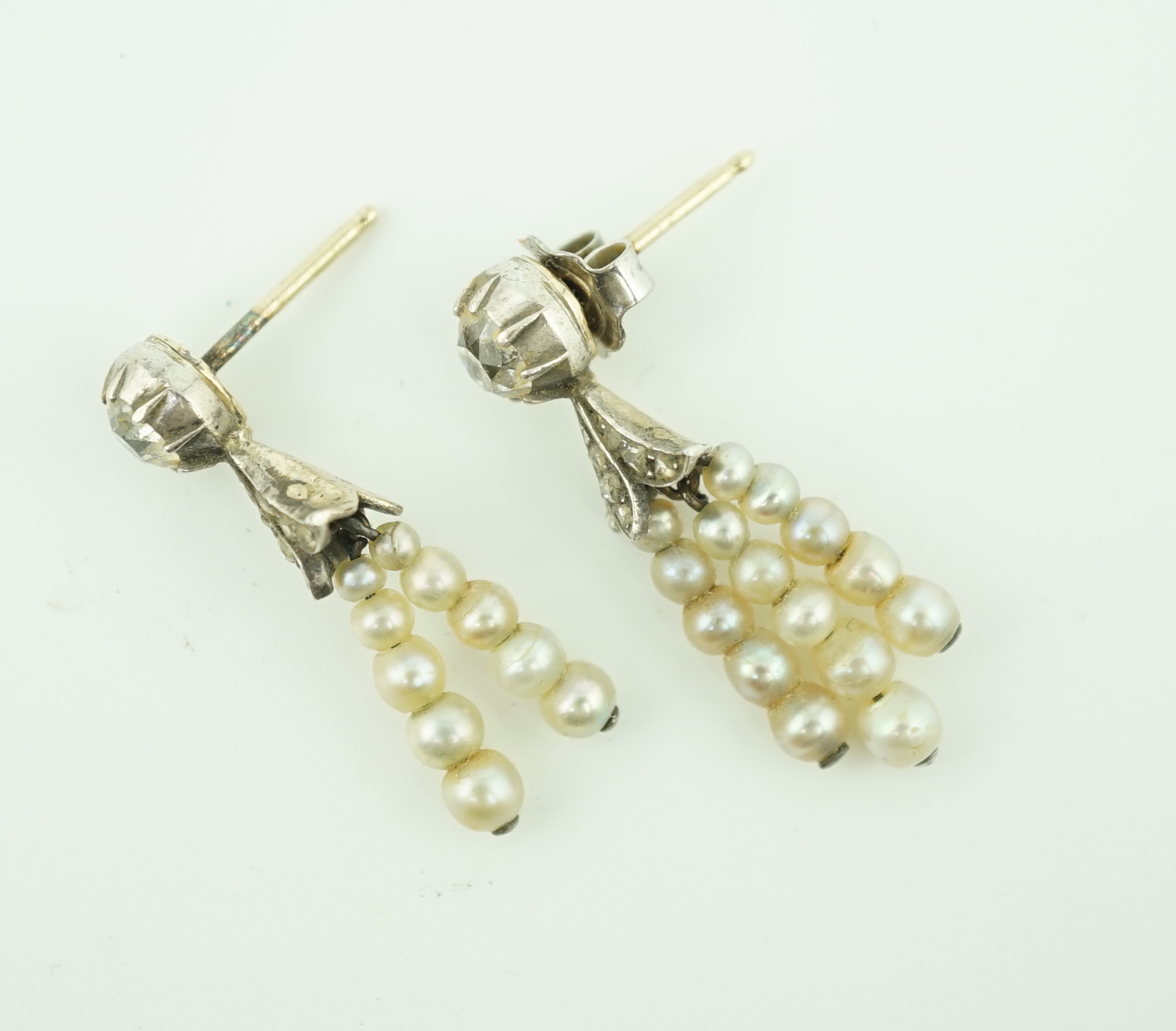 A pair of antique gold, graduated seed pearl, cushion and rose cut diamond set tassel drop earrings